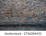 Authentic medieval stone wall texture from Semur-en-Auxois, France. Ancient limestone masonry with rough irregular blocks. Historical architectural background of a fortress or castle wall.