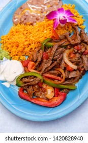 Authentic Mexican cuisine steak fajitas with rice and refried pinto beans