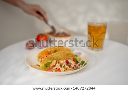 Authentic mexican tacos with beer. Mexican tacos with ground meat, beef, beans, onions and salsa