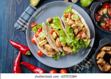 Authentic mexican tacos with chicken and salsa with avocado, tomatoes and chillies. Mexican cuisine. Top view