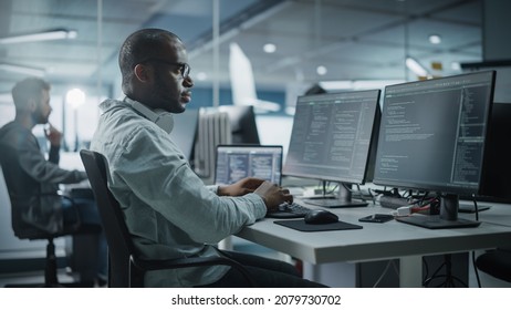Authentic Office: Enthusiastic Black IT Programmer Starts Working on Desktop Computer. Male Website Developer, Software Engineer Developing App, Video Game. Terminal with Coding Programming Language - Powered by Shutterstock