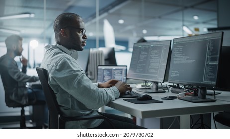 Authentic Office: Enthusiastic Black IT Programmer Starts Working On Desktop Computer. Male Website Developer, Software Engineer Developing App, Video Game. Terminal With Coding Programming Language