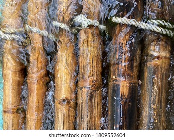 Authentic old bamboo raft texture very closed up shot, natural flow or stream in natural river in Thailand attached with white color nylon robe, while it was floating in water with empty copy space