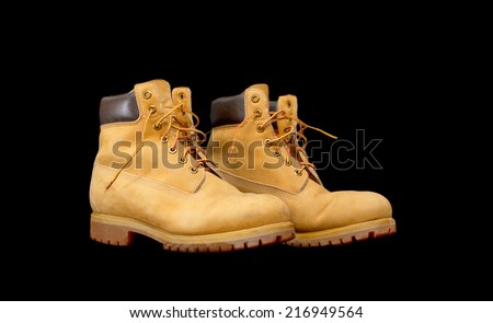 Authentic pair of 8 inch Yellow Work Boots isolated on black