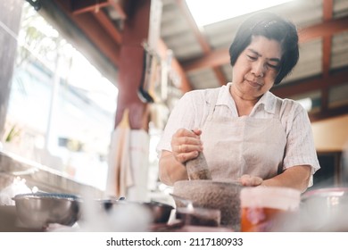 Authentic Portrait Asian Elderly Woman. Cooking With Love For Family Dinner Food Concept. Local Traditional Thai Style Indoors Kitchen At Home.