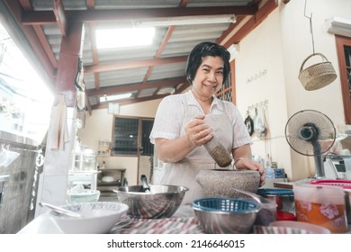 Authentic Portrait Asian Elderly Woman. Cooking With Love For Family Dinner Food Concept. Local Traditional Thai Style Indoors Kitchen At Home. Eye Looking At Camera.