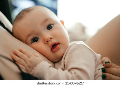 Authentic Portrait Of A Little Girl Hugging Mom. Weekdays Of An Ordinary Family Where A Mother Takes Care Of A Little Daughter