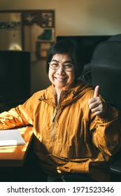 Authentic Portrait Of Smile Asian Elderly Mother. Asia Face Adult Older People With Happy Expression Wear Yellow Shirt.