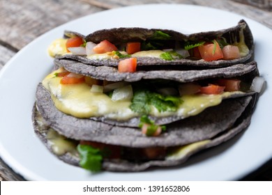 Authentic quesadillas with blue corn tortillas and mexican sauce