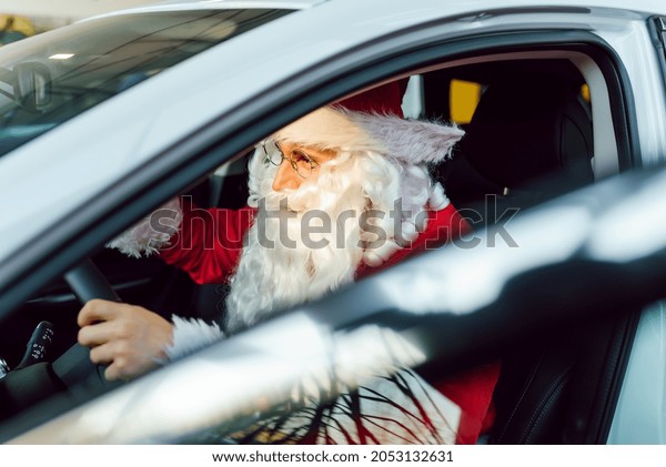 Authentic\
Santa Claus driving his modern car,\
outdoors