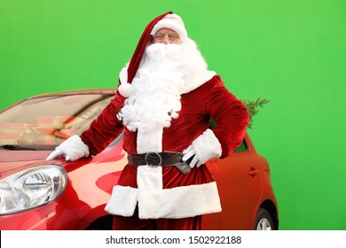 Authentic Santa Claus near car with fir tree and presents against green background - Powered by Shutterstock