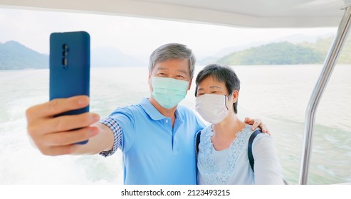 Authentic Shot Of Asian Elderly Couple Wearing Face Mask Take Selfie By Mobile Phone Happily On Boat In Close Up