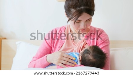 Similar – Image, Stock Photo Mother breast feeding and hugging her baby boy outdoors.