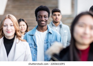 Authentic Shot Multiracial Crowd Of People In The City Walking On The Pavement Commuting To Work - Lifestyle And City Life Concepts With Young People - Focus On Smiling Black Man