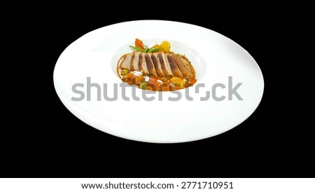 Authentic Thai roasted duck red curry (Gaeng Phed Ped Yang) in a modern white plate on black  background.