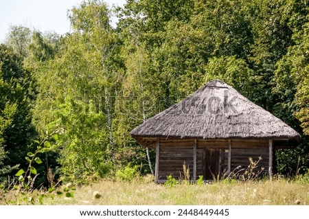 Authentic Ukrainian house in countryside. Summer village in Ukraine. Old folk thatched house. Ukrainian traditional rustic house. Rural countryside in summer ranch. Old architecture, copy space.