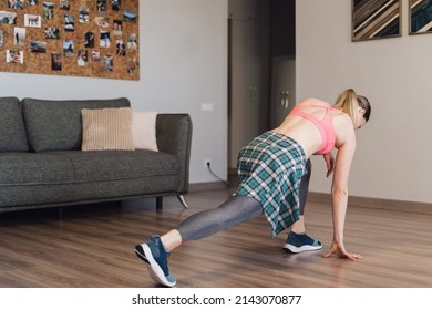 Authentic Woman Wearing A Sport Top And Leggings Stretching Home Warming Up Body For Dance.