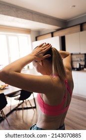 Authentic Woman Wearing A Sport Top And Leggings Stretching Home Warming Up Body For Dance.