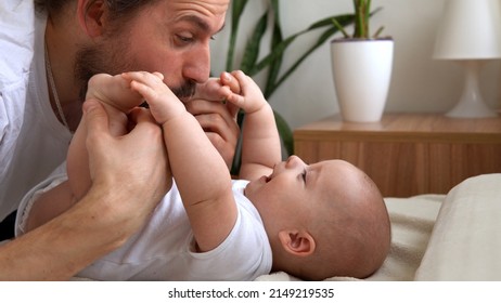 Authentic Young Bearded Man Holding Newborn Baby. Dad And Child Son On Bed. Close-up Portrait of Smiling Family With Infant On Hands. Happy Marriage Couple On Background. Childhood, Parenthood Concept - Powered by Shutterstock