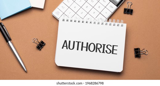 AUTHORISE on notepad with pen, glasses and calculator