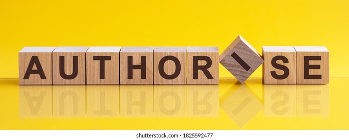 AUTHORISE word written on wood block. AUTHORISE text on table, concept. Word AUTHORISE is made of wooden building blocks lying on the table and on a light yellow background.
