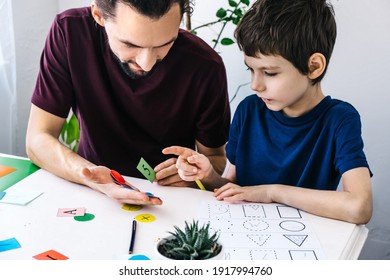 Autism Awareness Concept. Autism Schoolboy During Therapy At Home With His Tutor With Learning And Having Fun Together.
