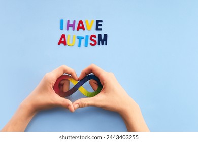 Autistic boy hands and rainbow eight infinity symbol. Autism awareness day symbol. - Powered by Shutterstock