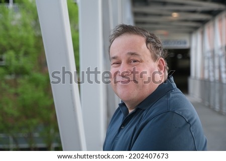 Autistic middle aged man gesturing.