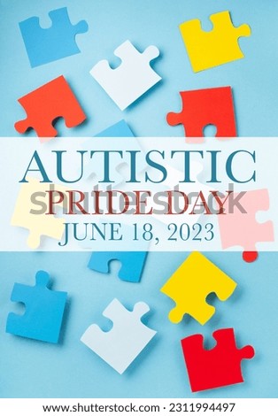 Autistic Pride Day concept. Creative design for June 18. Color puzzle, symbol of awareness for autism spectrum disorder on blue background. Top view, copy space.