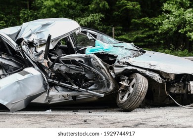 Auto accident. Crashed car in the street. Damaged car after collision - Shutterstock ID 1929744917