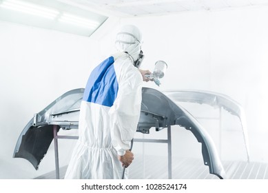 Auto Body Repair Series: Mechanic Painting Car Bumper In Paint Booth