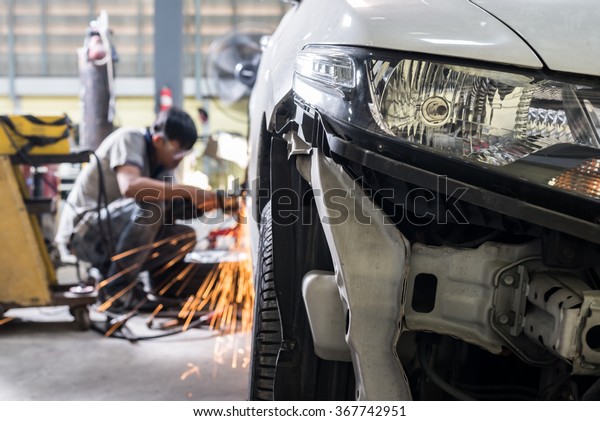 Auto\
body repair series :  Mechanic grinding car\
body