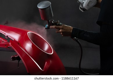 Auto-Body-Reparaturserie: roter Stoßfänger in Farbkabine gemalt
