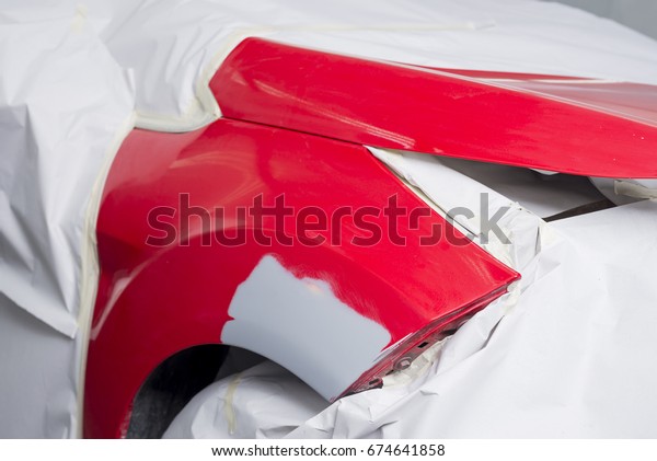 Auto body repair series: Red car after being
masked waiting for repaint