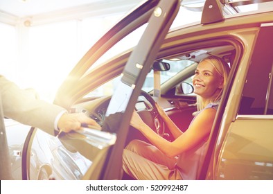 Auto Business, Car Sale, Consumerism And People Concept - Happy Woman With Car Dealer In Auto Show Or Salon