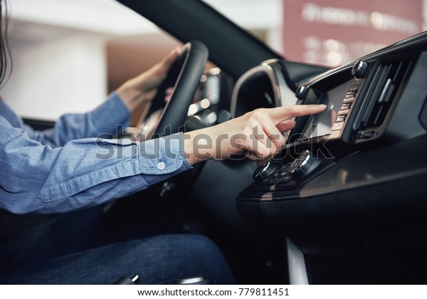 auto\
business, car sale, consumerism and people concept - happy woman\
taking car key from dealer in auto show or\
salon.
