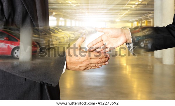 auto business, car sale, deal, gesture and people\
concept - close up of dealer giving hand to new owner and shaking\
hands in auto show or\
salon