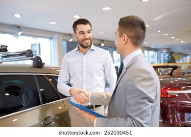 Auto Business, Car Sale, Technology, Gesture And People Concept - Happy Man And Car Dealer With Tablet Pc Computer Shaking Hands In Auto Show Or Salon