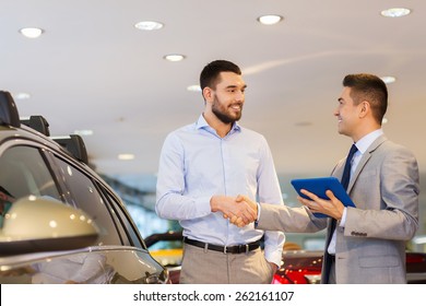 Auto Business, Car Sale, Technology, Gesture And People Concept - Happy Man And Car Dealer With Tablet Pc Computer Shaking Hands In Auto Show Or Salon