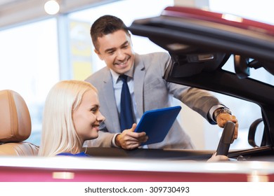 Auto Business, Car Sale, Technology And People Concept - Happy Woman And Car Dealer With Tablet Pc Computer In Auto Show Or Salon