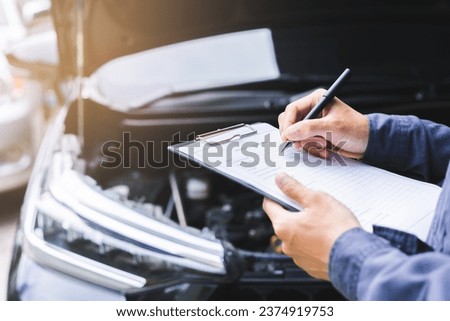 Auto check, car service shop concept. Automobile repairman writing job checklist on clipboard, mechanic checking engine to estimate repair machine, inspecting maintenance by engineer at vehicle garage Сток-фото © 