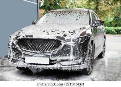 Auto with cleaning foam at car wash - Powered by Shutterstock