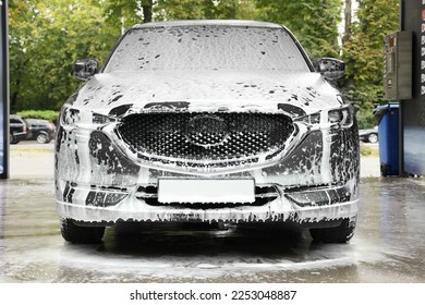 Auto with cleaning foam at car wash - Powered by Shutterstock