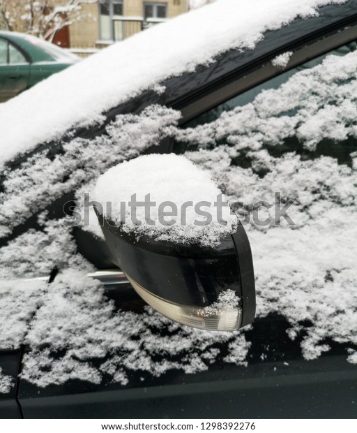 Auto covered with snow in\
winter .