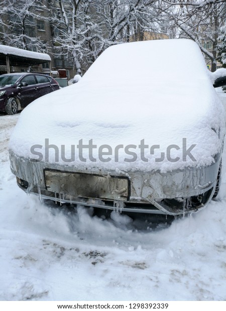 Auto covered with snow in\
winter .