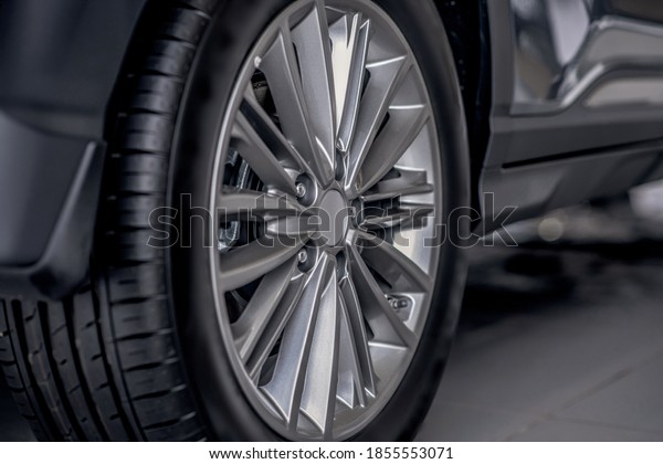 Auto\
dealership. Close-up picture of black rear\
tyre