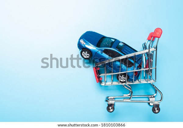 auto dealership and rental car concept. blue\
car shopping cart blue\
background