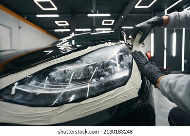 Auto Detailer Isolating Automotive Headlamp With Adhesive Strip