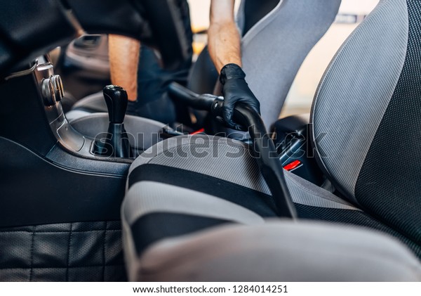 Auto\
detailing, cleaning seats with vacuum\
cleaner