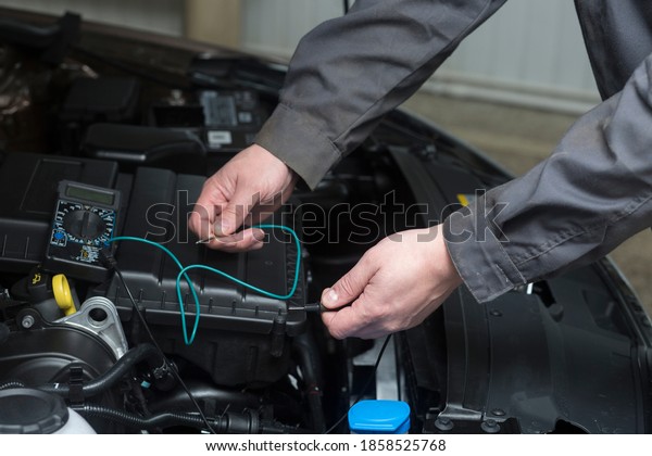 Auto electrician. Work of an
auto electrician in a car service station.Checking the
car.